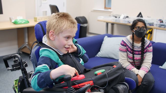 Elliot Button Push Smiling boy in wheelchair using adapted gaming setup