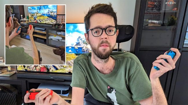 Zak23_1000 Young man holding two Nintendo Switch joycons