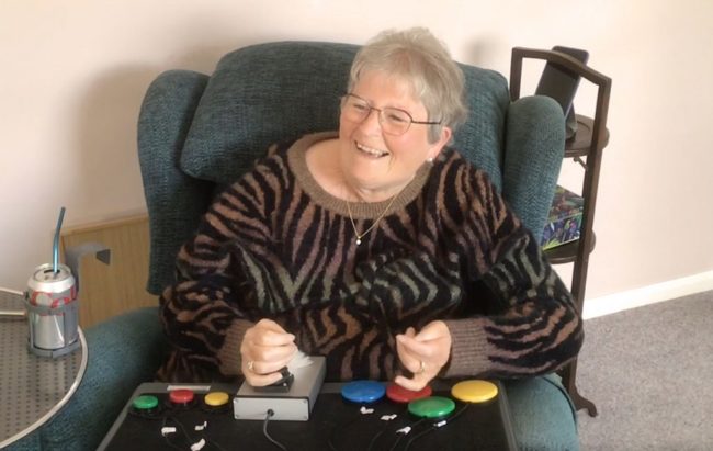 Brenda_1000_osd-1024×648 Lady in armchair using an adapted gaming setup