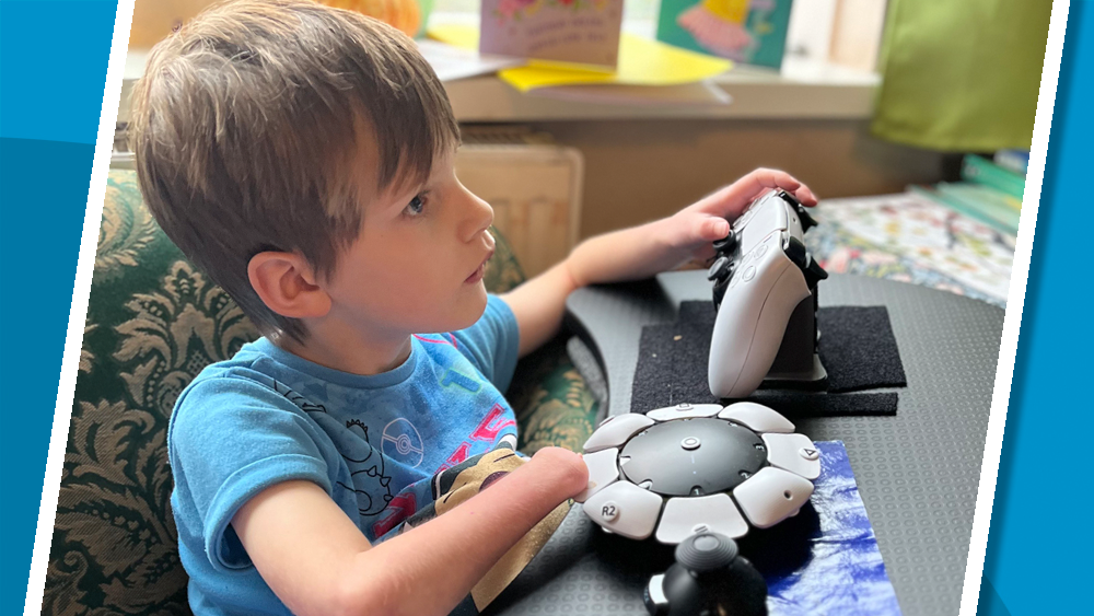 Young girl using two adaptive gaming controllers